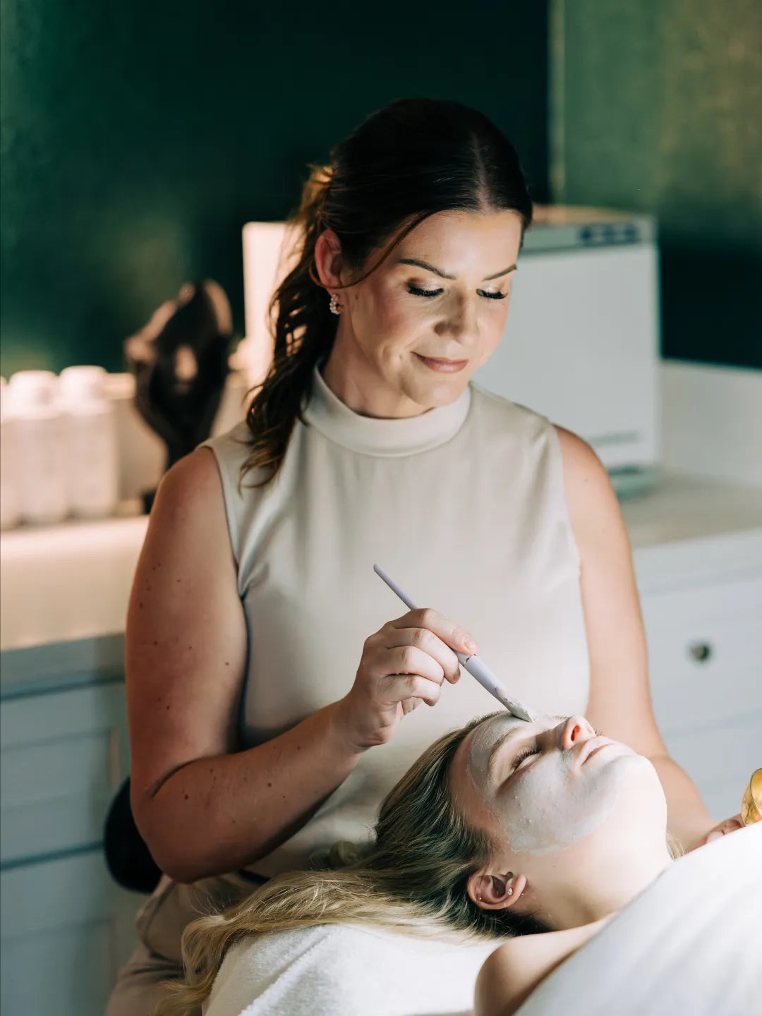Client receiving facial treatment
